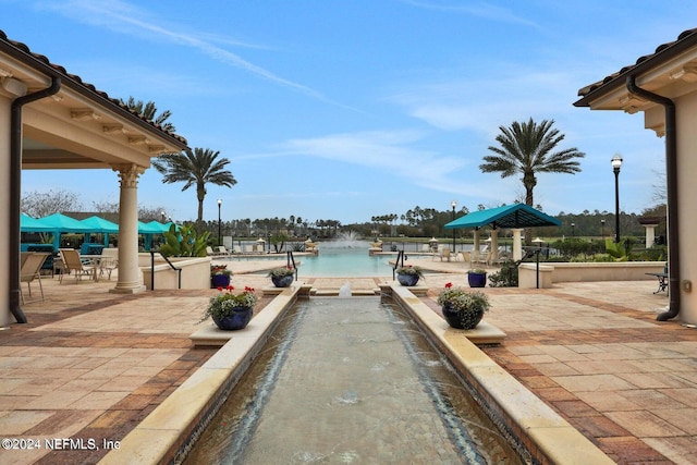 view of patio with pool water feature