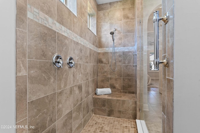 bathroom with a tile shower