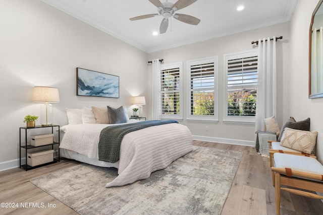 bedroom featuring ceiling fan, light hardwood / wood-style floors, and ornamental molding