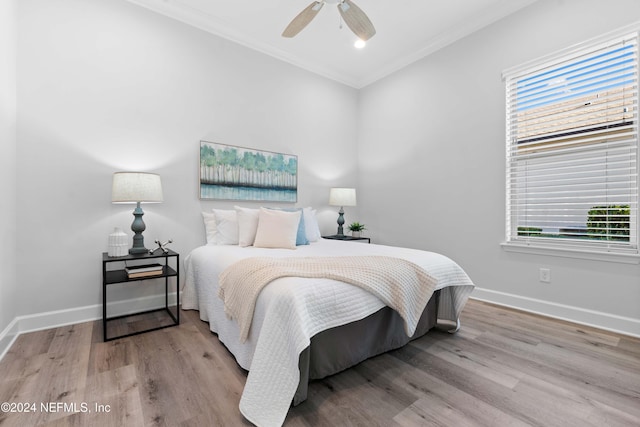 bedroom with ceiling fan, ornamental molding, and light hardwood / wood-style flooring