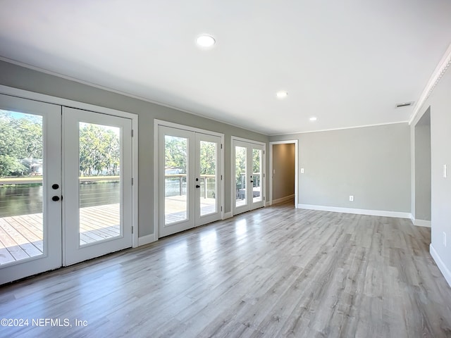 interior space featuring light hardwood / wood-style floors, french doors, and crown molding