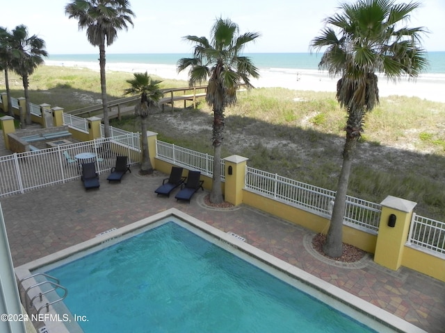 1031 1st St S Unit 504, Jacksonville Beach, FL 32250 - view of pool with fence, a water view, a beach view, and a patio area