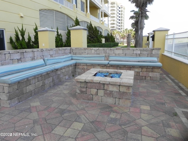 1031 1st St S Unit 504, Jacksonville Beach, FL 32250 - view of patio featuring an outdoor fire pit