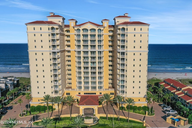 view of building exterior with a view of the beach and a water view