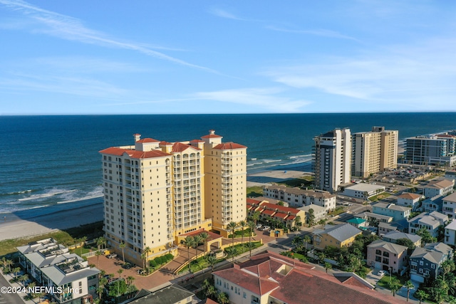 drone / aerial view featuring a view of the beach and a water view