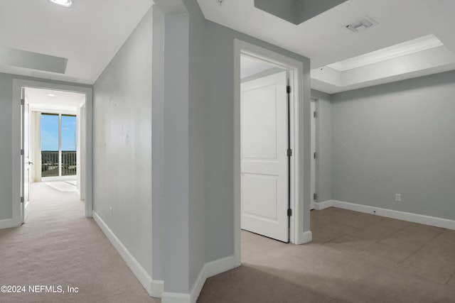 hall featuring light carpet and crown molding