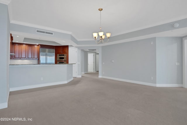 unfurnished living room featuring light carpet, a chandelier, a tray ceiling, and crown molding