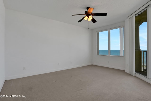 1031 1st St S Unit 504, Jacksonville Beach, FL 32250 - spare room featuring baseboards, a ceiling fan, and light colored carpet