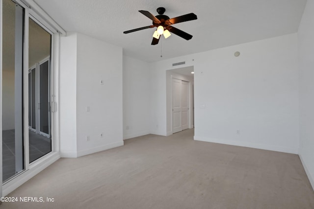 1031 1st St S Unit 504, Jacksonville Beach, FL 32250 - empty room with light carpet, a textured ceiling, baseboards, visible vents, and ceiling fan