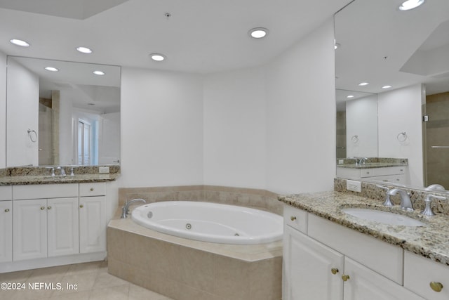 bathroom with independent shower and bath, tile patterned flooring, and vanity