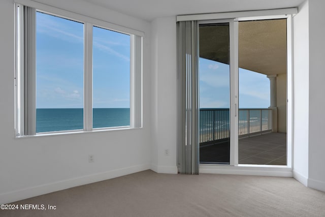 1031 1st St S Unit 504, Jacksonville Beach, FL 32250 - spare room with baseboards, carpet flooring, and a water view