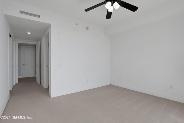 carpeted empty room featuring ceiling fan