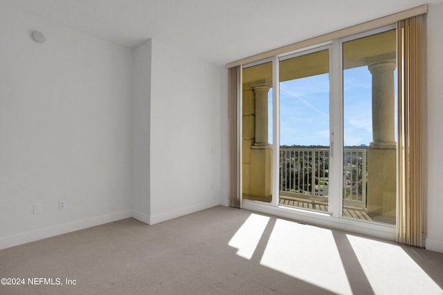 1031 1st St S Unit 504, Jacksonville Beach, FL 32250 - carpeted empty room featuring baseboards and floor to ceiling windows
