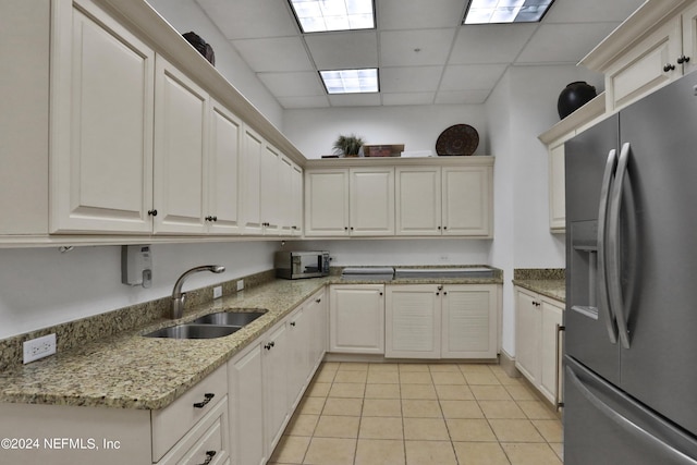 1031 1st St S Unit 504, Jacksonville Beach, FL 32250 - kitchen with a sink, light stone countertops, appliances with stainless steel finishes, light tile patterned floors, and a drop ceiling