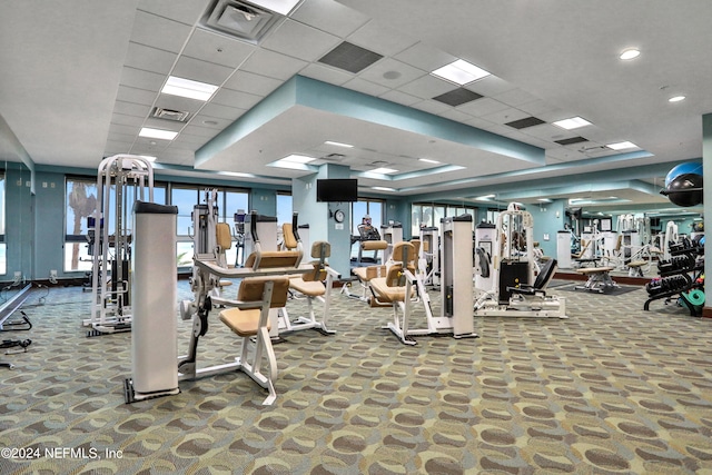 exercise room with a drop ceiling and carpet floors