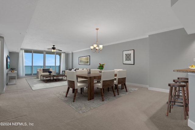 dining room featuring light carpet, ceiling fan with notable chandelier, and ornamental molding