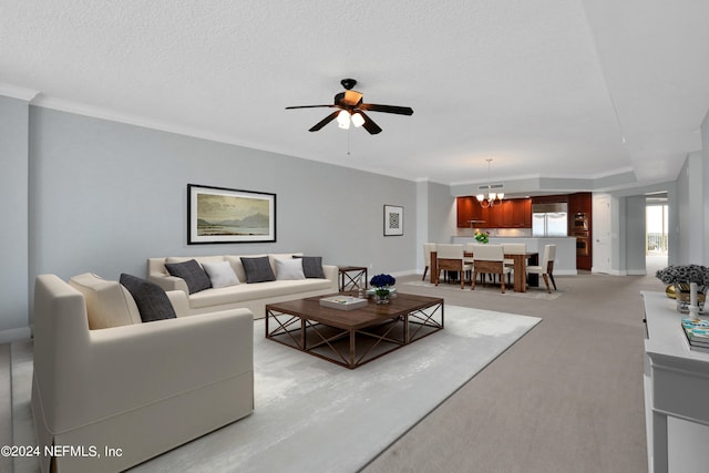 carpeted living room featuring ceiling fan with notable chandelier, a textured ceiling, and ornamental molding