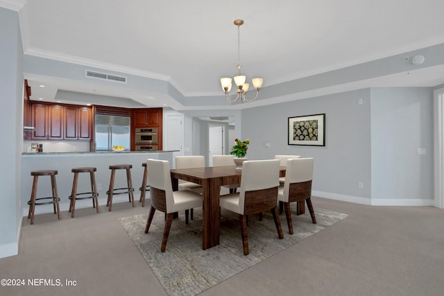 carpeted dining room with a notable chandelier, a raised ceiling, and crown molding