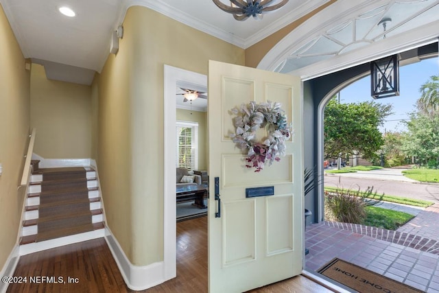 entrance foyer with wood-type flooring, ceiling fan, and crown molding