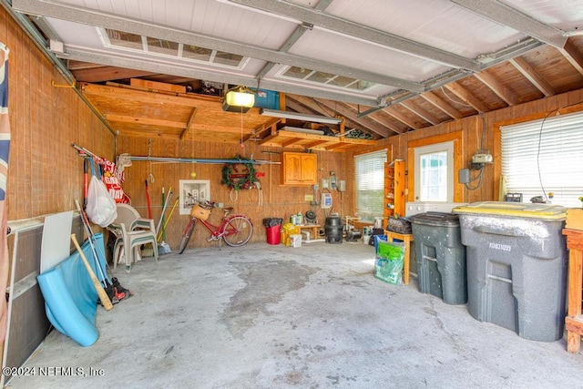 garage featuring wooden walls and a garage door opener