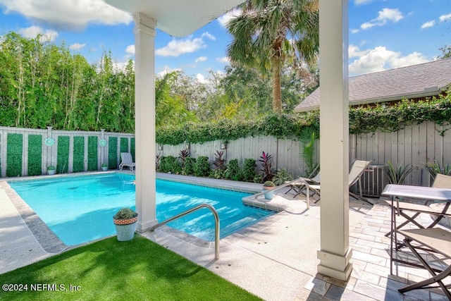 view of swimming pool with central AC unit and a patio area