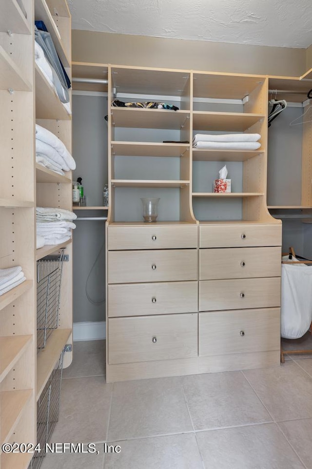 spacious closet featuring light tile patterned flooring