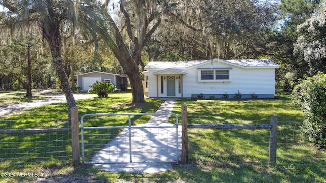 ranch-style home with an outbuilding, a garage, and a front yard