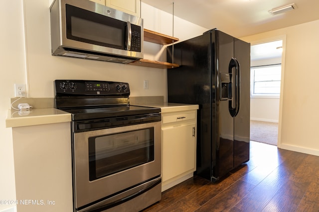 kitchen with white cabinets, stainless steel appliances, and dark hardwood / wood-style floors