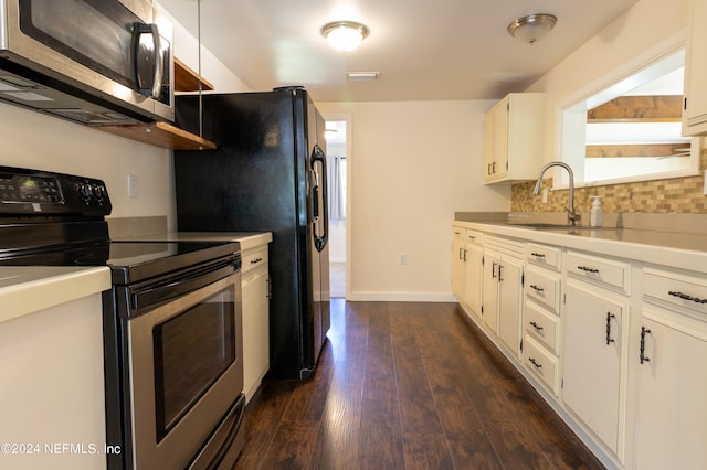 kitchen with white cabinets, sink, stainless steel appliances, dark hardwood / wood-style floors, and decorative backsplash