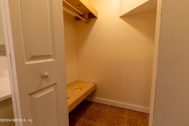 walk in closet featuring dark tile patterned floors