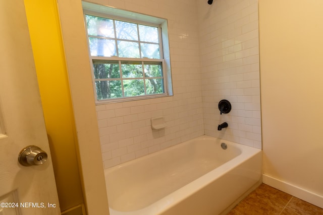 bathroom with tile patterned flooring and tiled shower / bath