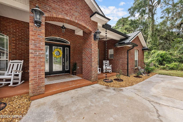 view of exterior entry featuring covered porch