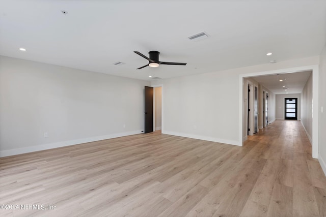 unfurnished room with ceiling fan and light wood-type flooring