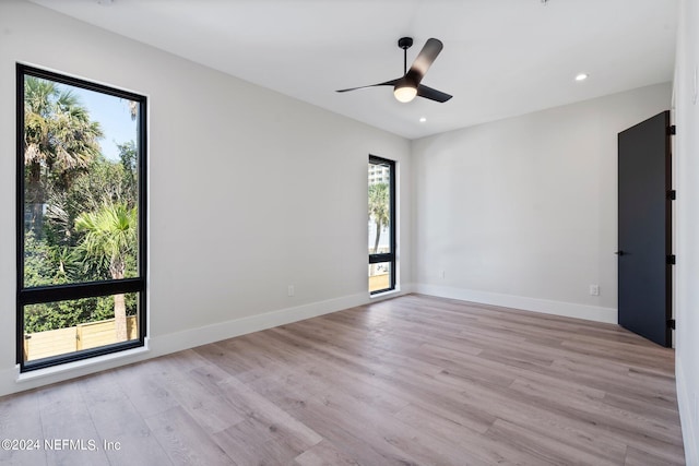 spare room featuring ceiling fan and light hardwood / wood-style flooring