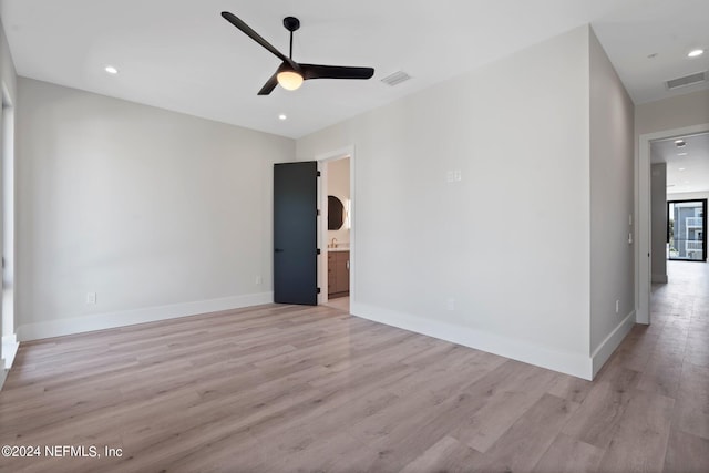 empty room featuring ceiling fan and light wood-type flooring