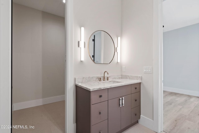 121 12th Ave S, Jacksonville Beach, FL 32250 - bathroom featuring vanity, baseboards, and wood finished floors