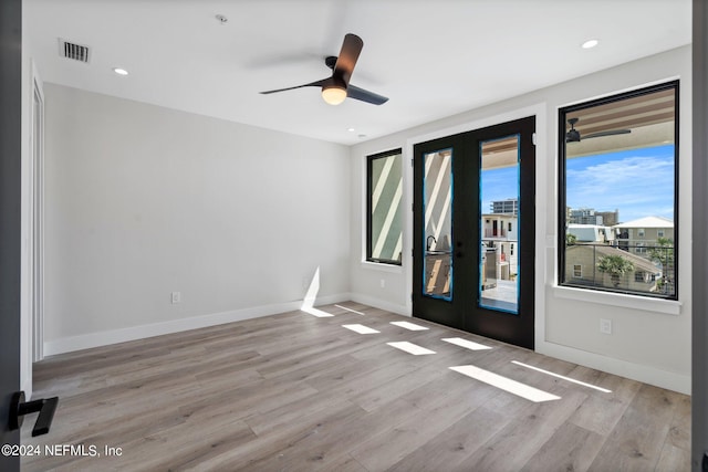 interior space featuring light wood-type flooring, french doors, and ceiling fan