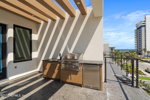 view of patio / terrace featuring a balcony, sink, and area for grilling