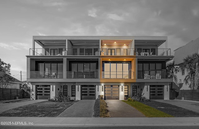 view of front of home featuring a garage and a balcony