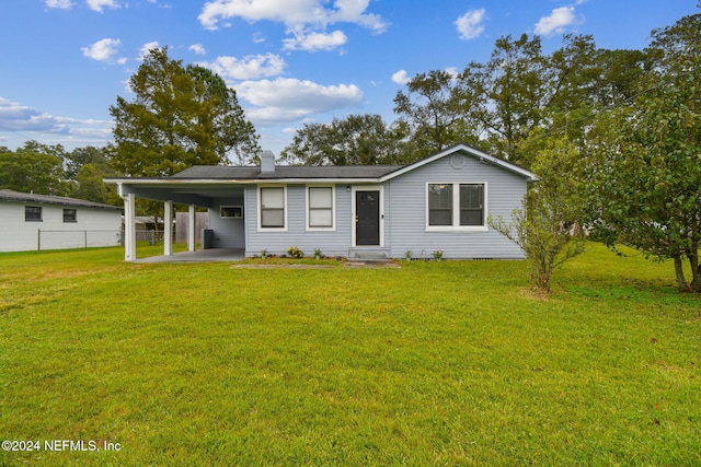 single story home with a front lawn and a carport