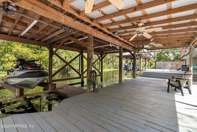 wooden terrace featuring ceiling fan and a boat dock