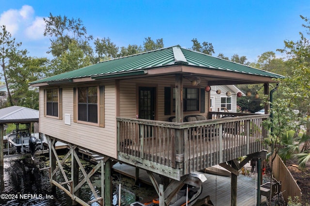 back of property with metal roof and a standing seam roof