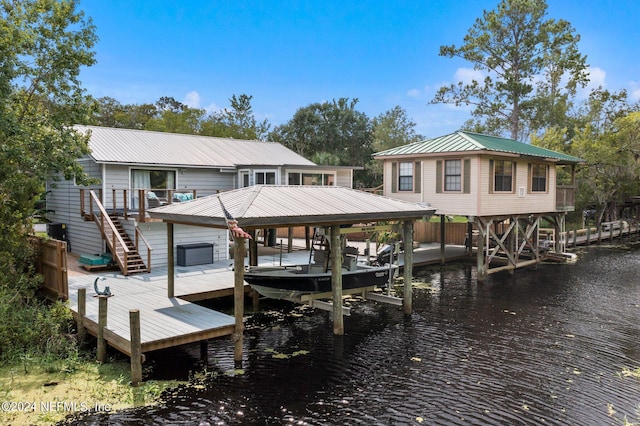 view of dock featuring boat lift, a water view, and stairway