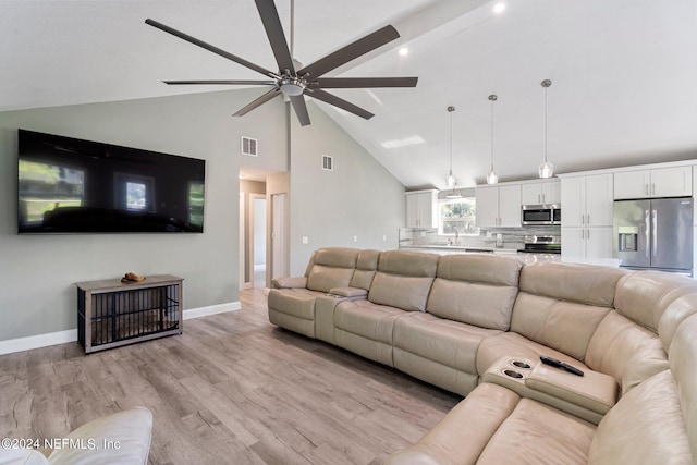 living area featuring baseboards, visible vents, light wood-type flooring, and a ceiling fan