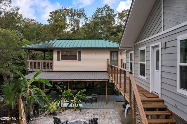 wooden terrace with a patio area