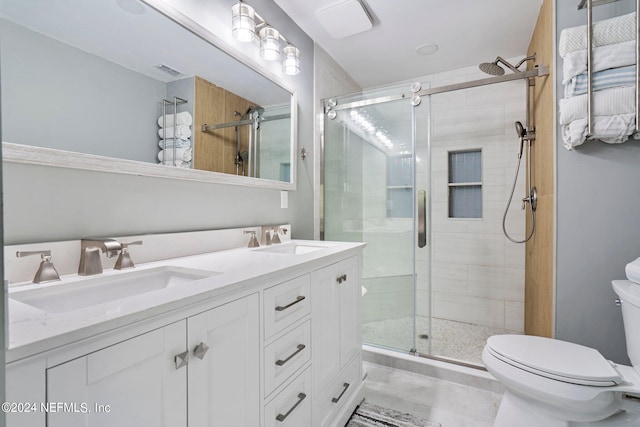 bathroom with toilet, vanity, and walk in shower