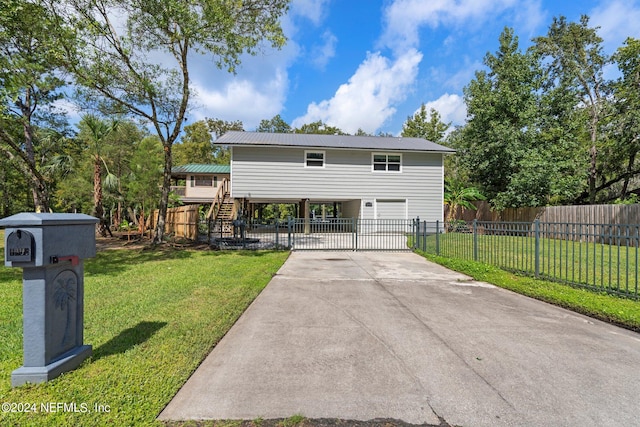 view of front of house featuring a garage and a front lawn