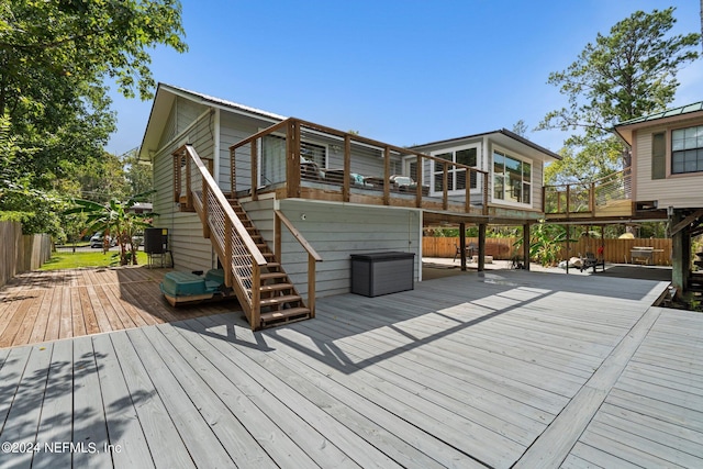 deck featuring fence and stairs