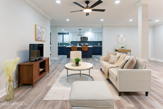 living area featuring baseboards, light wood-style floors, ceiling fan, and ornamental molding