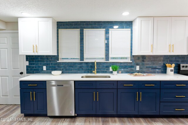 kitchen with white cabinets, sink, dishwasher, light wood-type flooring, and decorative backsplash